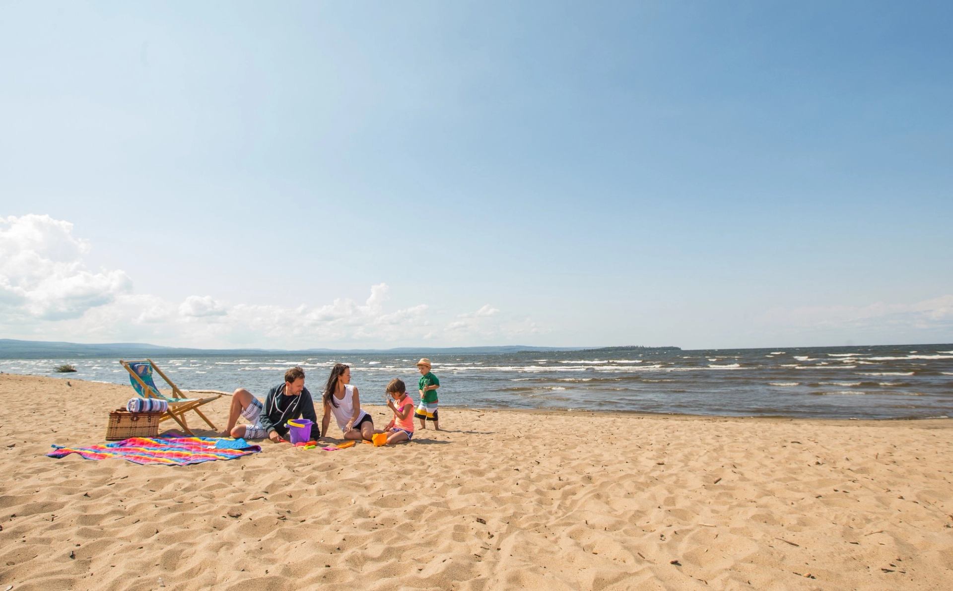 Family relaxing on the beach at Lesser Slave Lake Provincial Park.