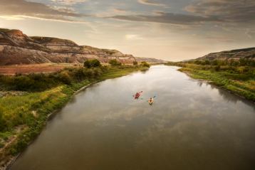 Scenic wide shot of people kayaking down the Red Deer River.