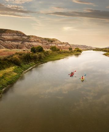 Scenic wide shot of people kayaking down the Red Deer River.