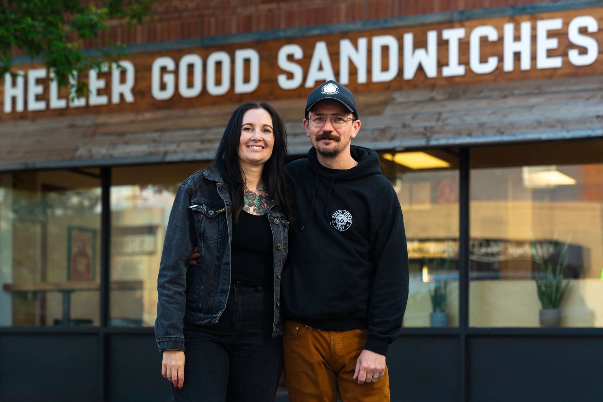 Portrait of the owners of Heller Good Sandwiches in front of their restaurant.