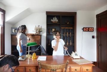 Mother and son looking around in an escape room.