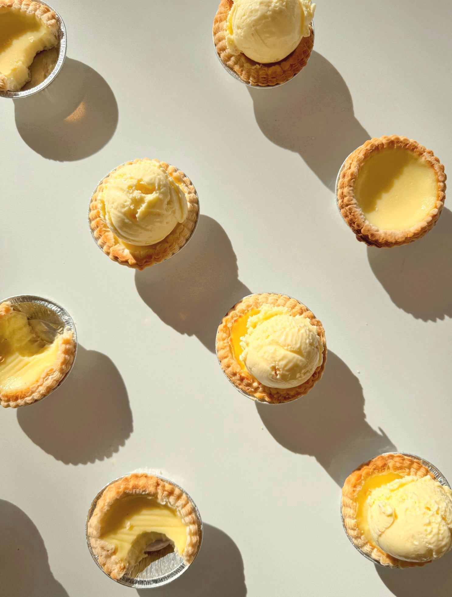 Top-down shot of tarts with ice cream scoops on top.