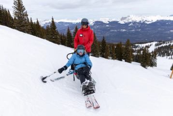 A skier uses a sit ski with a guide at Marmot Basin in Jasper National Park.