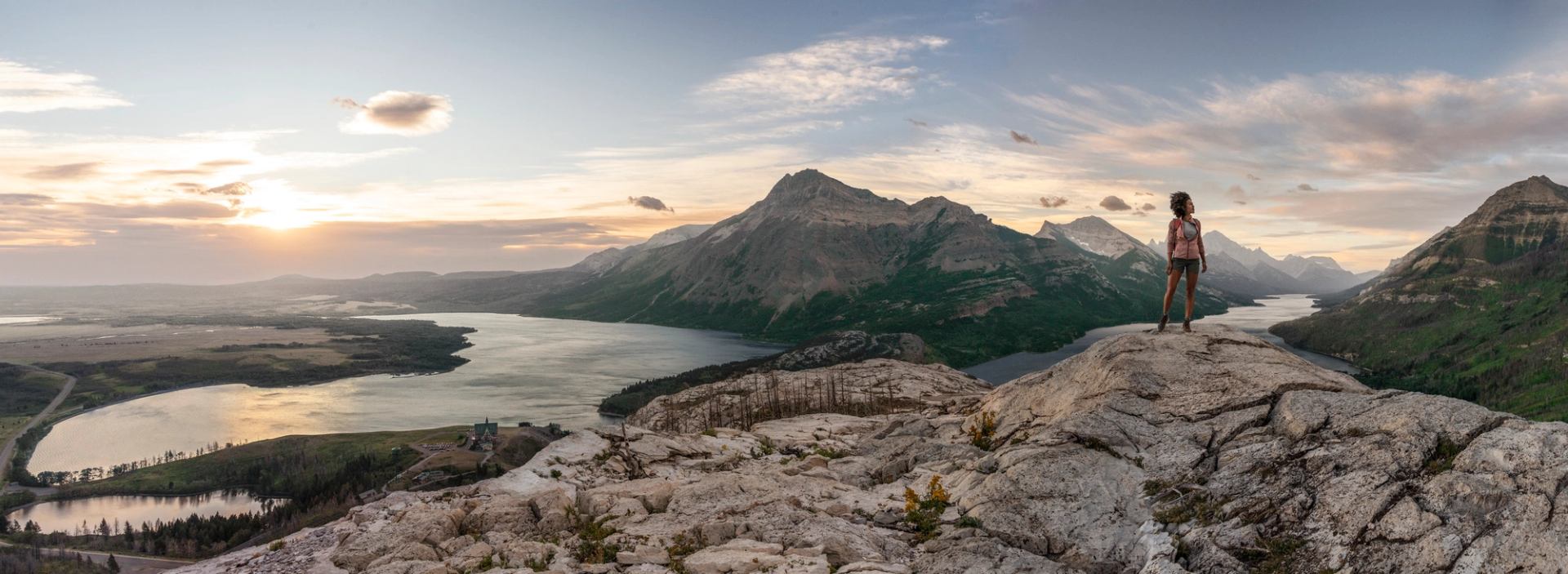 Person standing on top of mountain in Waterton Lakes National Park.