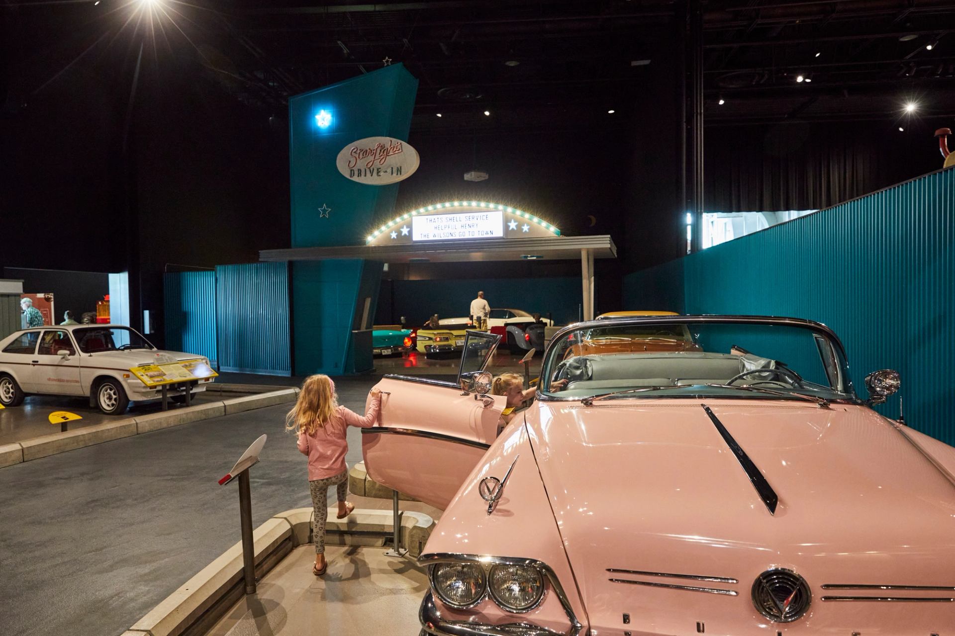 A young girl interacts with a pink car at the Reynolds-Alberta Museum in Wetaskiwin.