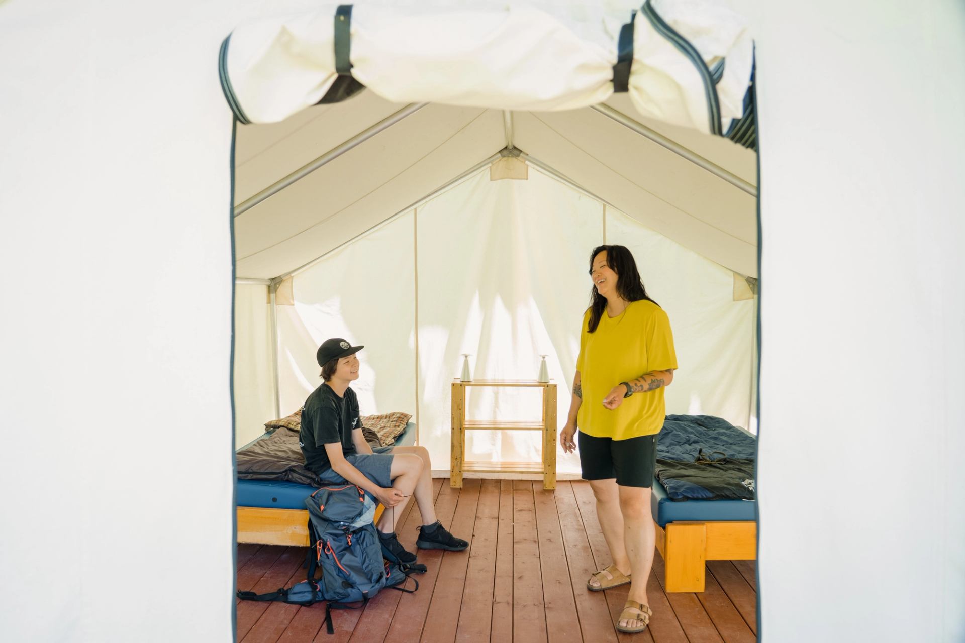 A mother and son inside a tent at Hideaway Adventure Grounds in Smoky Lake.