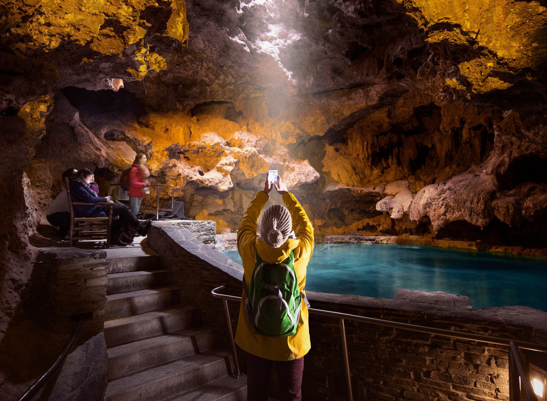 Tourist takes a picture inside a cave.