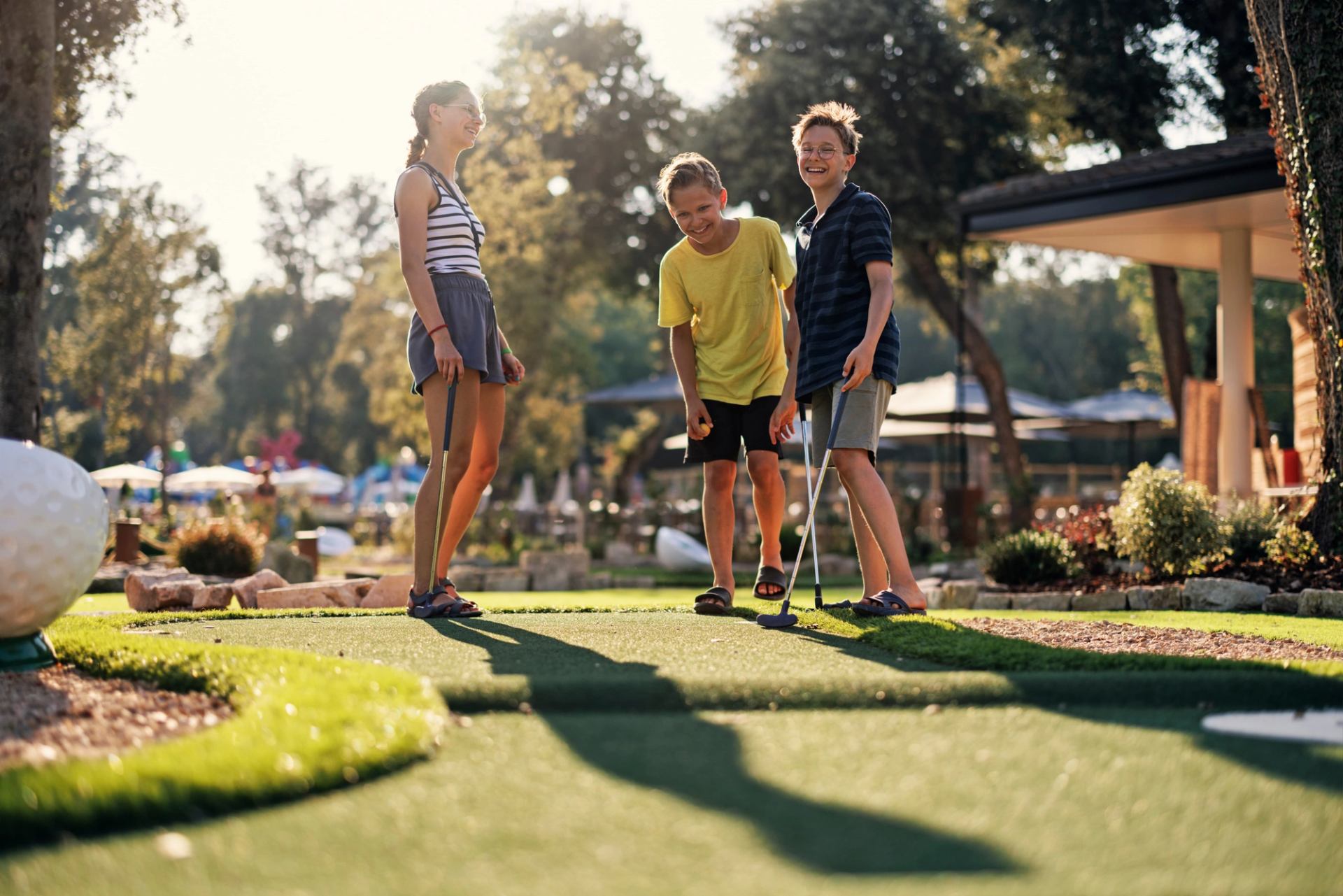 Kids playing mini golf