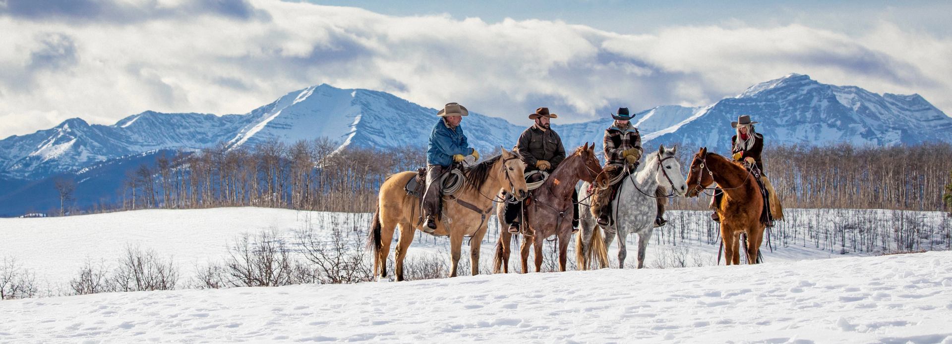 People horseback riding in winter.