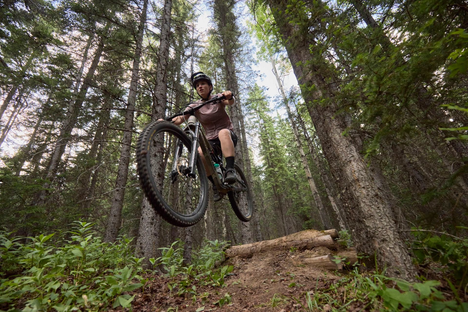 Riding mountain a bike on a trail and getting some air.