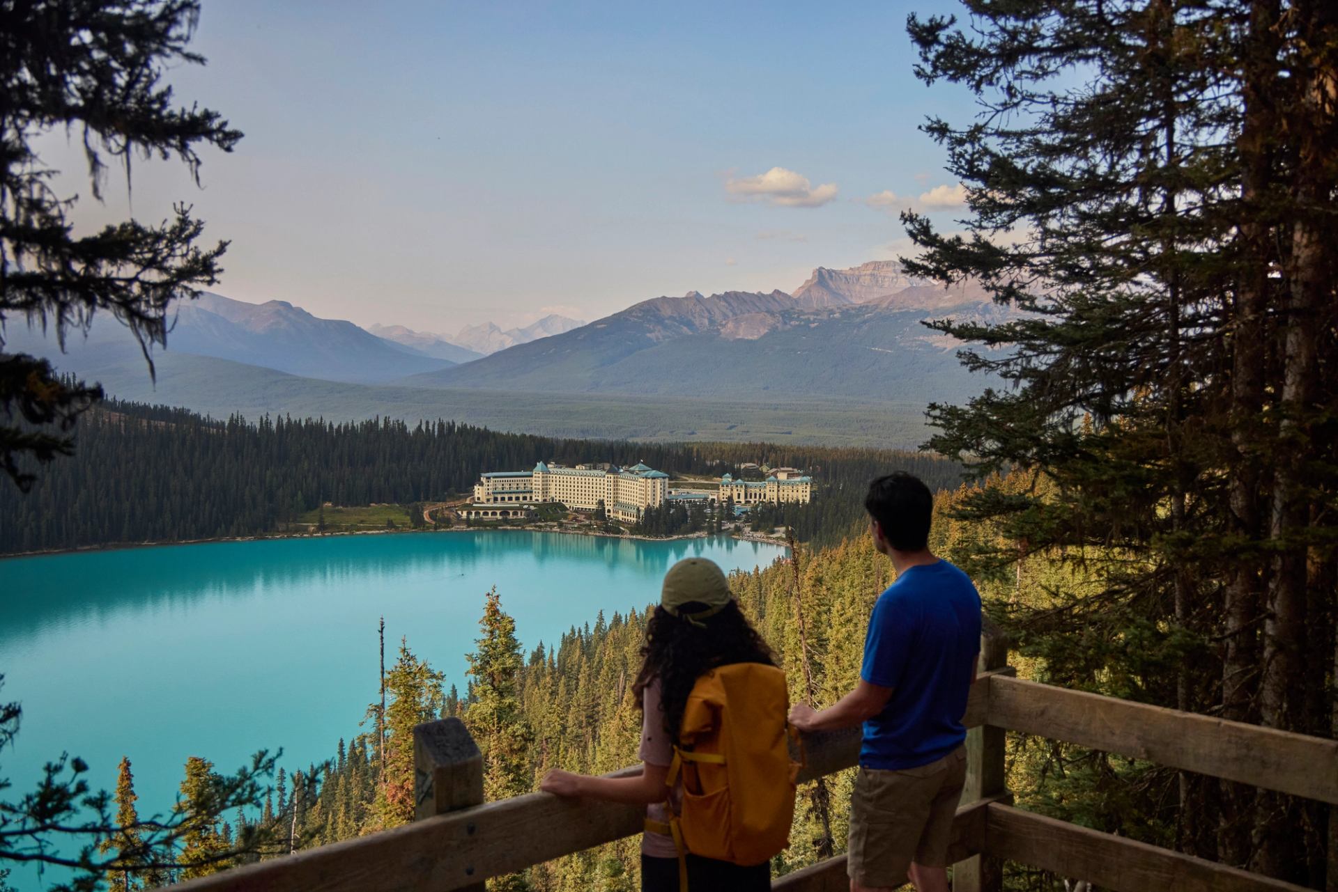 Couple at Fairview lookout looking over Lake Louise and Fairmont Chateau Lake Louise.