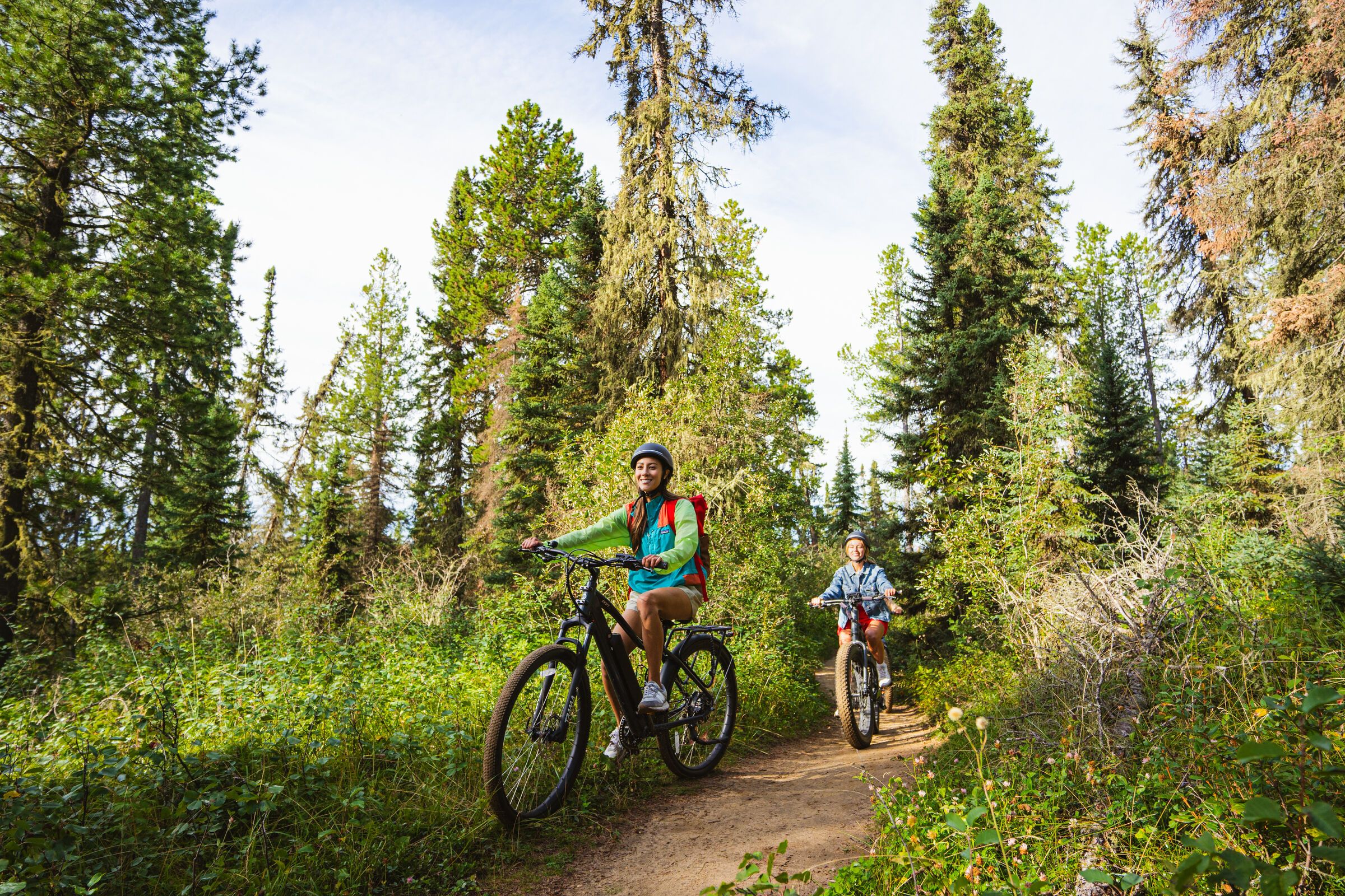 Riding bicycles on a trail at Twin Lakes Rocky Mountain House.