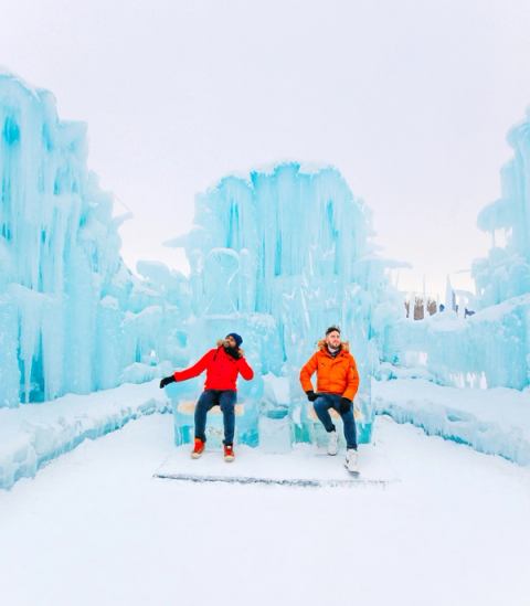 Two men sitting on an ice throne at the Edmonton Ice Castle, in Hawrelak Park