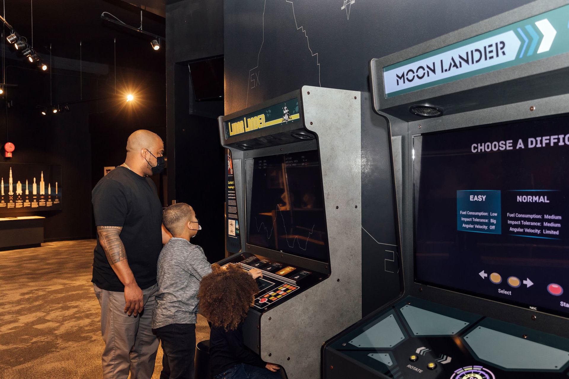 Science Centre visitors use a video game to simulate flying in space.