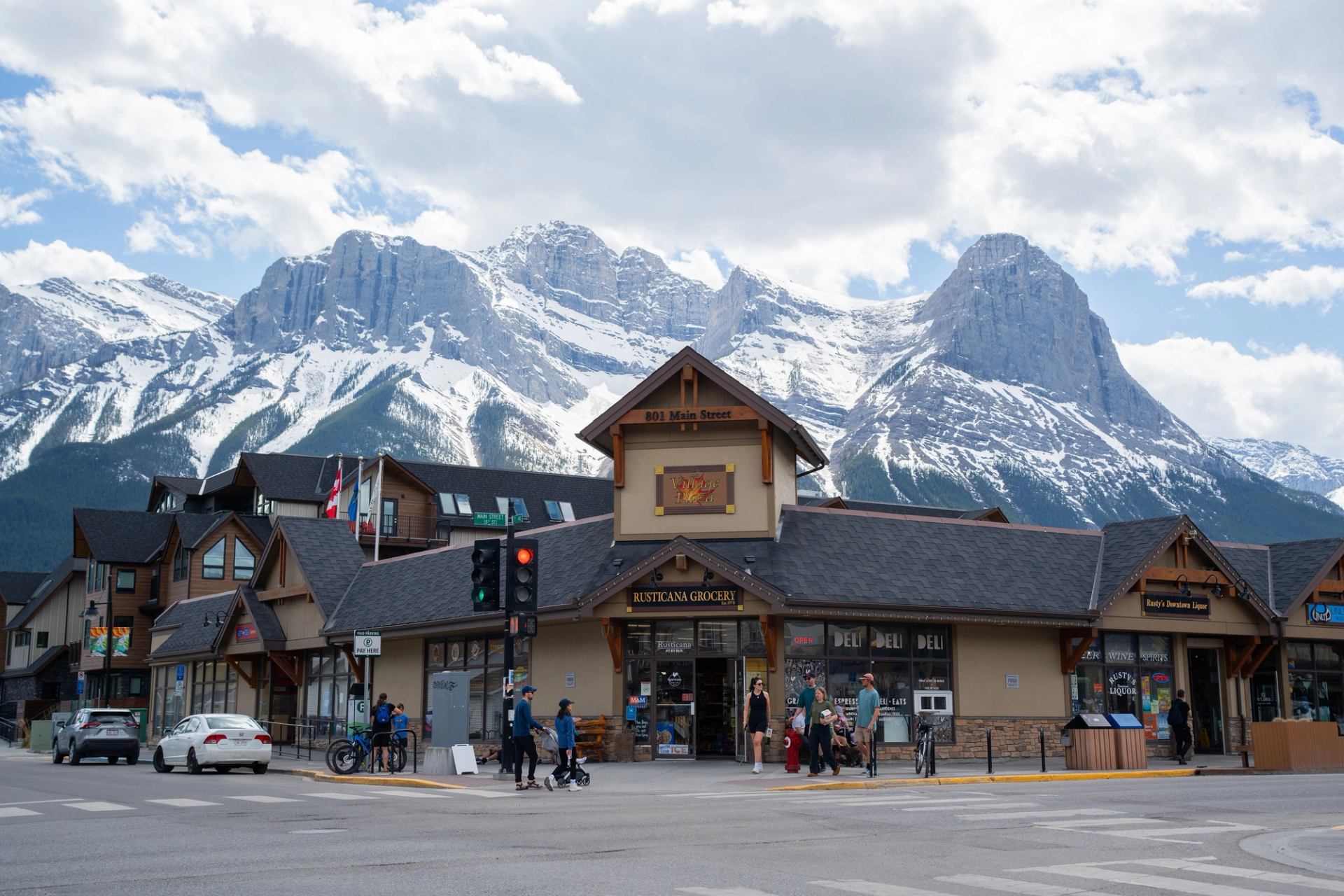 A charming grocery store on Main Street in Canmore, with the Canadian Rockies in the distance.