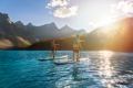 2 people paddle boarding on Moraine Lake