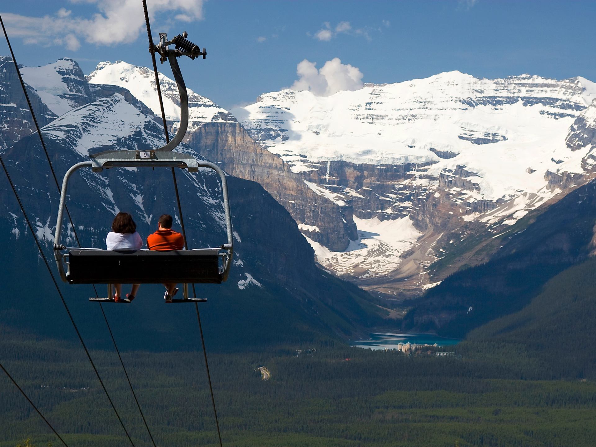 Couple on a gondola with Lake Louise in the background