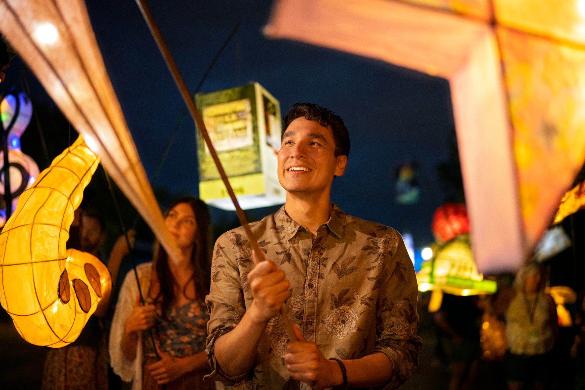 A man holds a lantern at the Edmonton Folk Music Festival