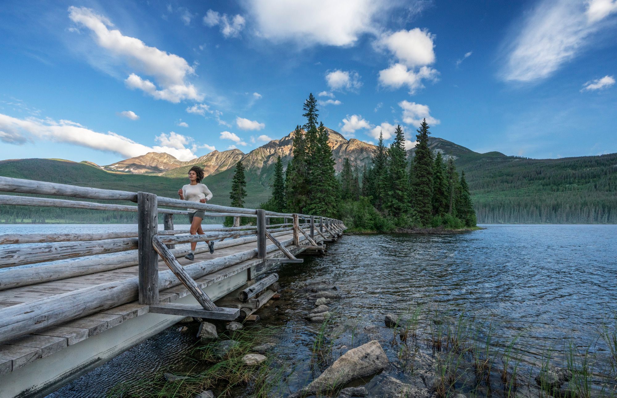 woman running across bridge pyramid lake jasper