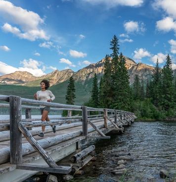 woman running across bridge pyramid lake jasper