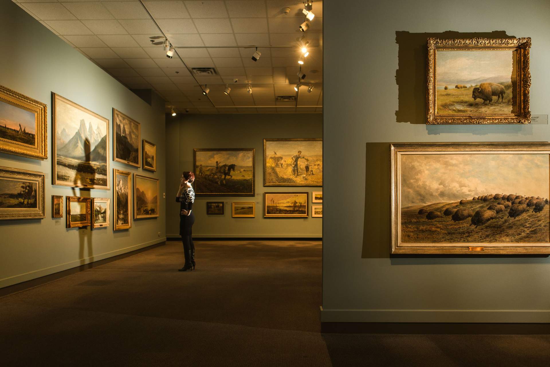 A woman looking at art in the Glenbow Museum