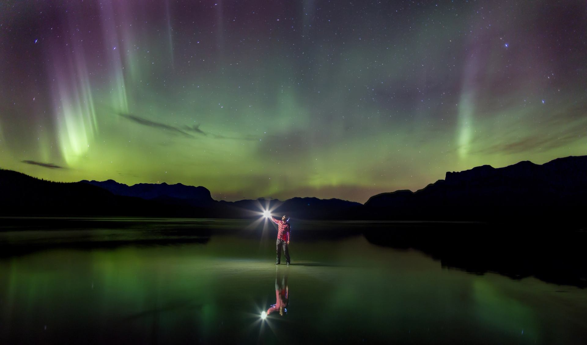 Person looking up at night sky and Northern lights