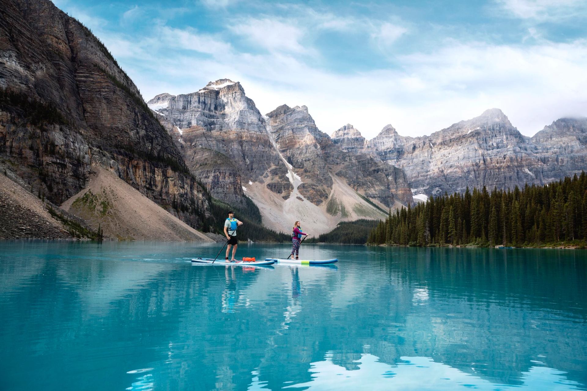 A couple out paddleboarding on Moraine Lake