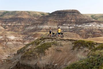 Couple mountain biking in the Badlands in Drumheller