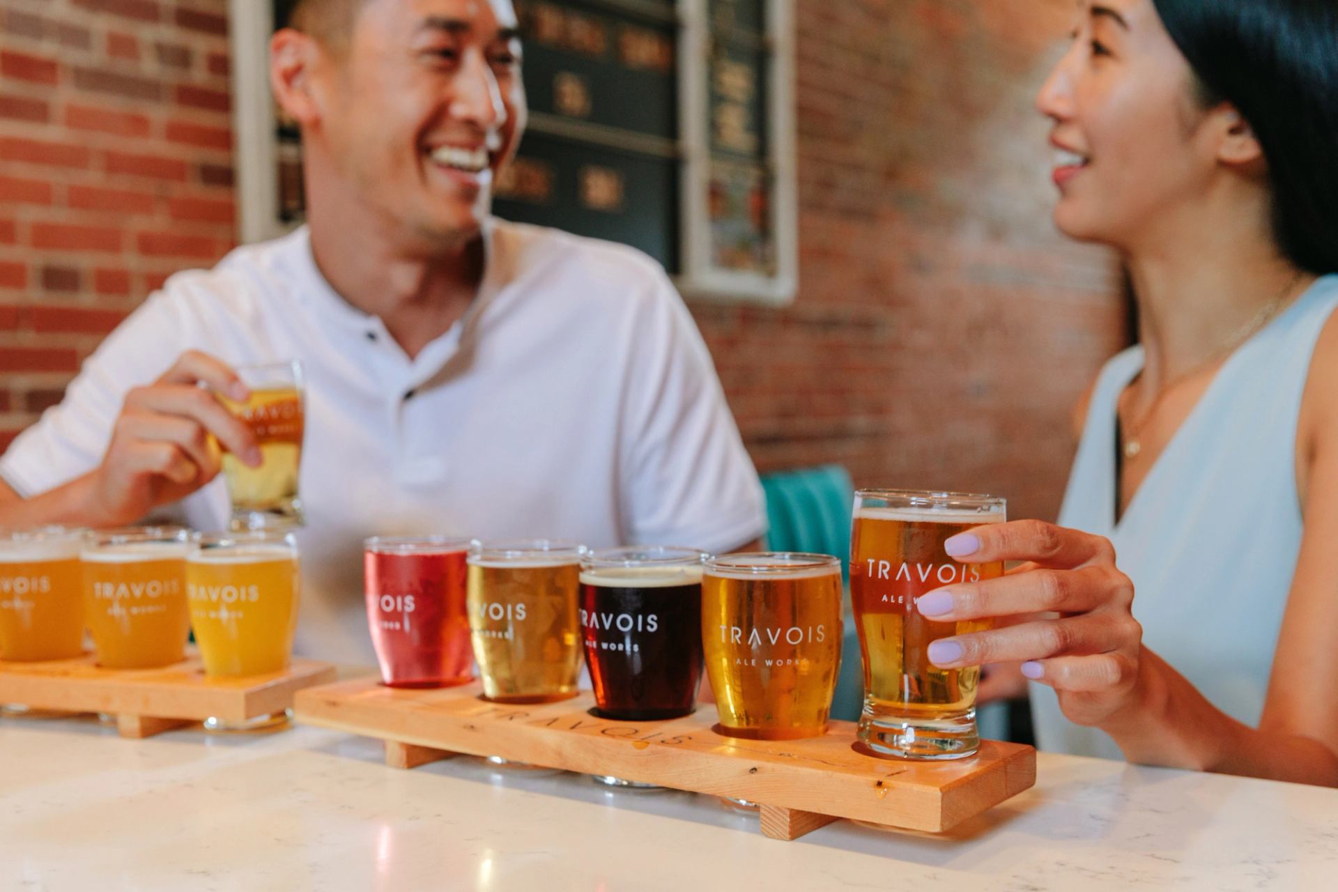 A couple enjoys a flight of beers at Travois Ale Works in Medicine Hat.