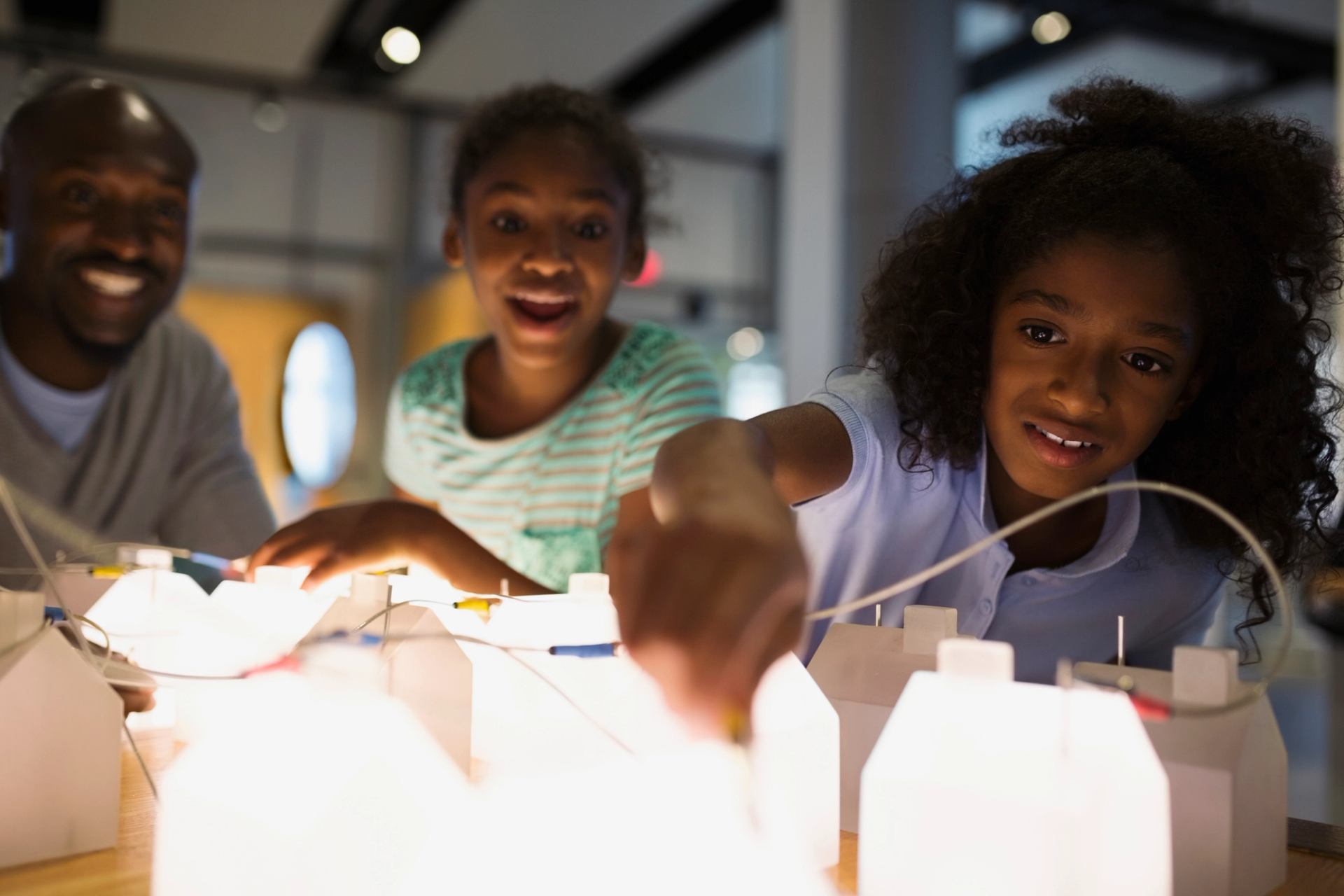 Family interacting with the Energy and Innovation Gallery path Telus Spark Science Centre in Calgary.