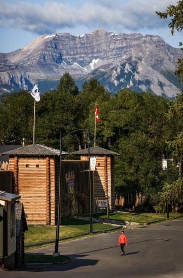 Wide angle view of a museum front entrance along a street with a mountain view.