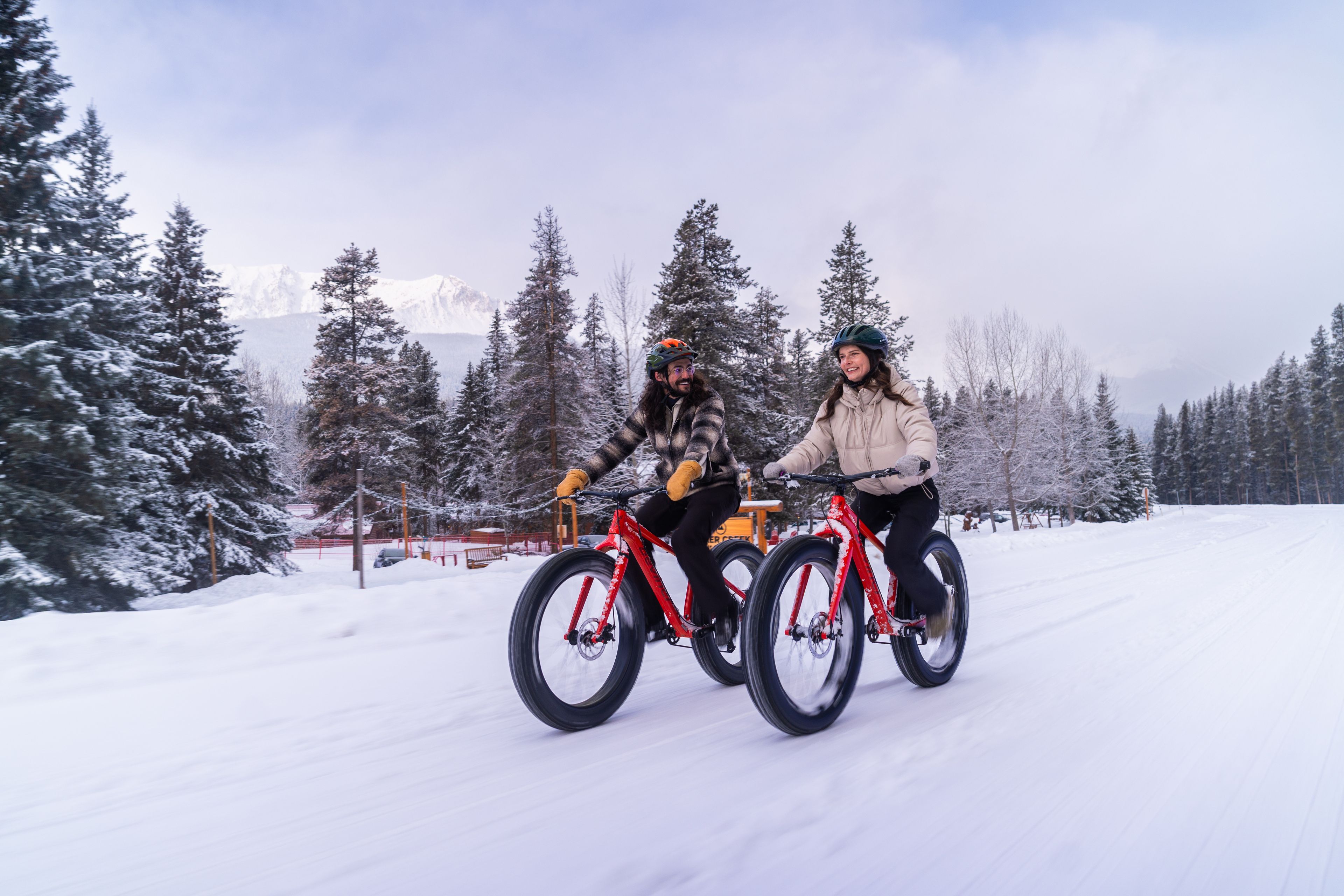 Couple riding fat bikes out at Baker Creek Cabins.