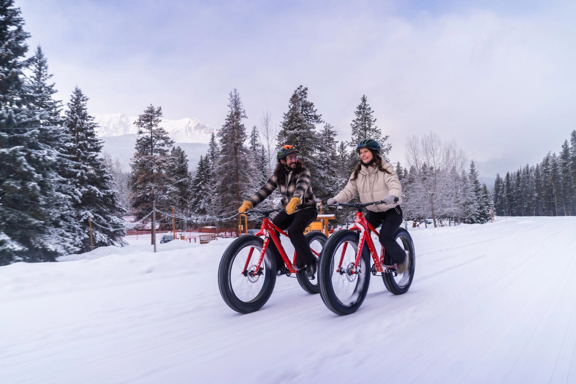 Couple riding fat bikes out at Baker Creek Cabins.