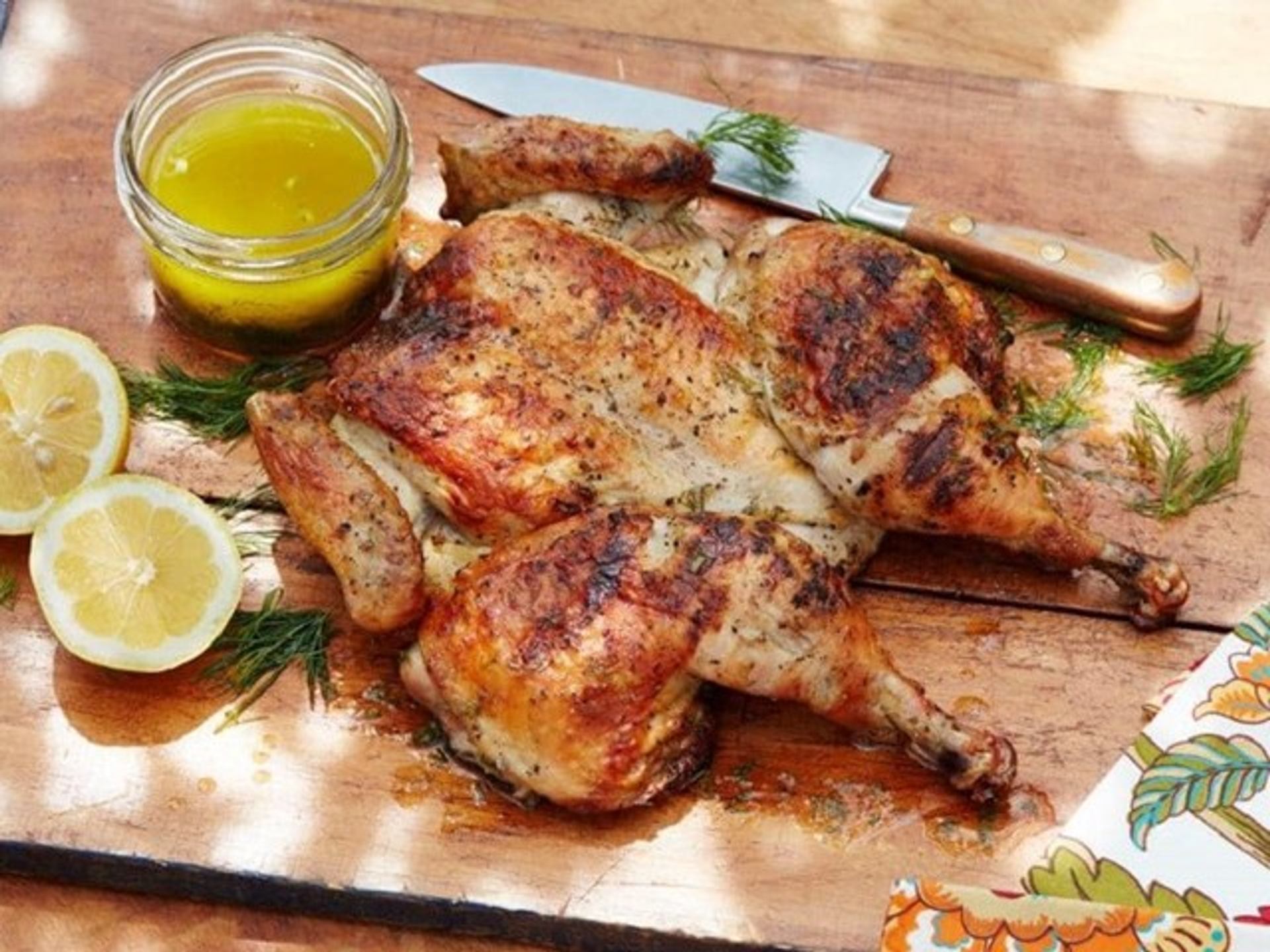 Cooked chicken on wooden cutting board