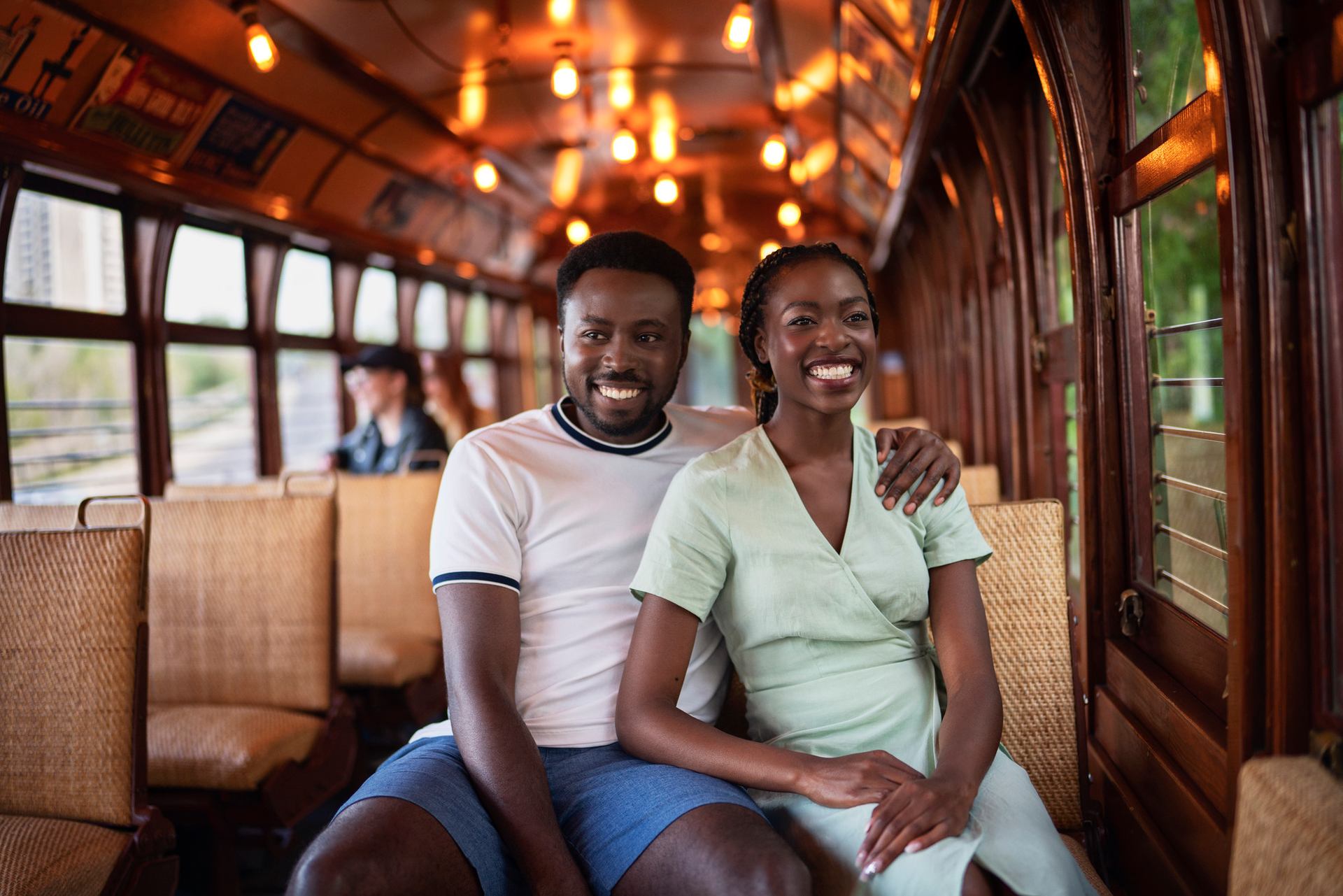 A smiling couple rides the artfully restored vintage streetcar in Edmonton.