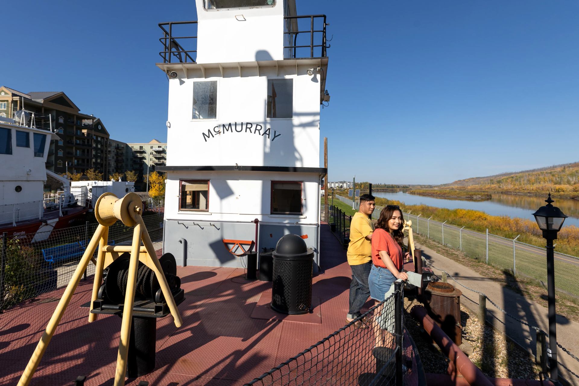 Couple looking towards the river at Fort McMurray Heritage Shipyard.