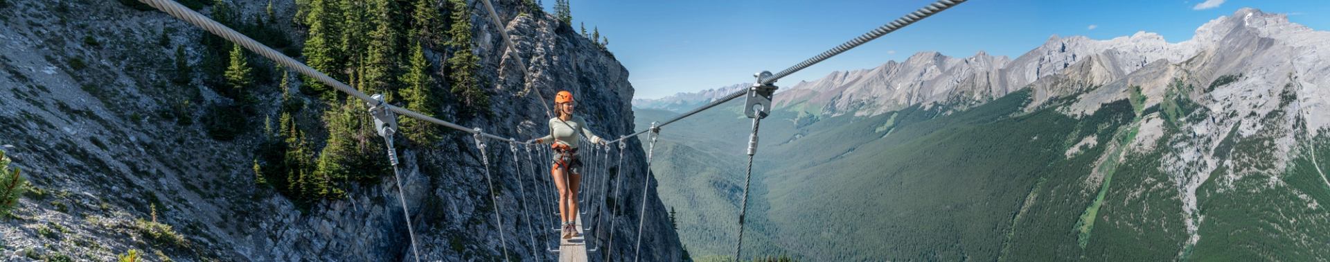 Women walking across suspension bridge at Mount Norquay