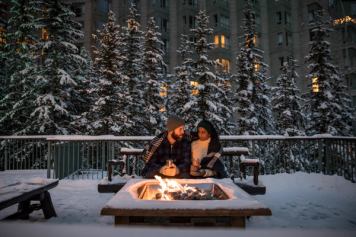 Couple around an outside fire at the Rimrock Hotel