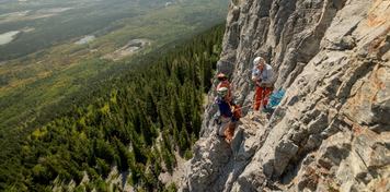 A group being shown climbing technique during a tour with Barry Blanchard and Yamnuska Mountain Adventures.