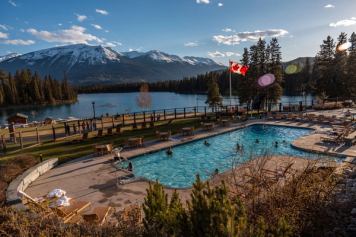People swimming in the outdoor pool at Jasper Park Lodge.