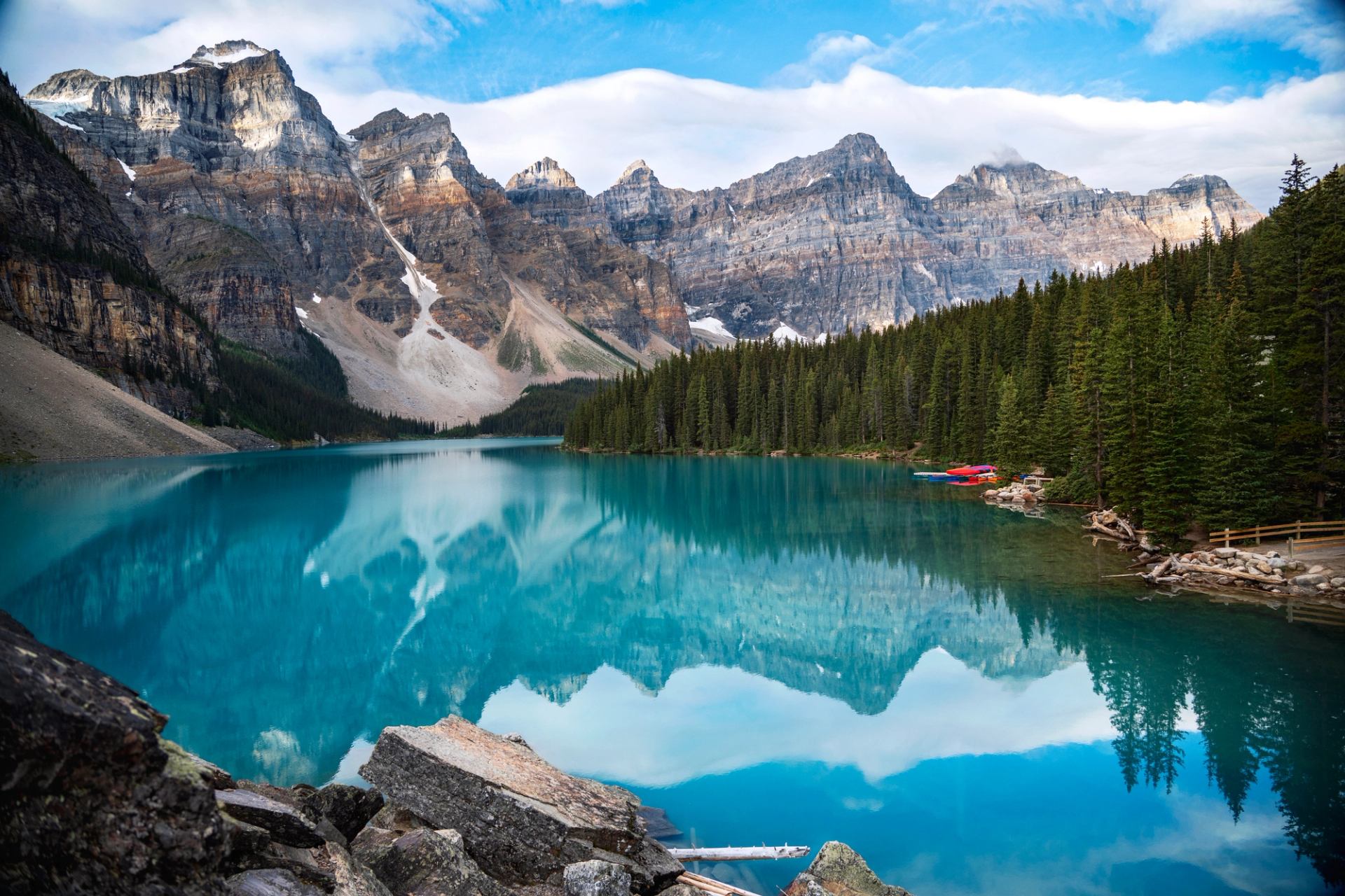 The turquoise-blue water of Moraine Lake reflects the peaks all around it.