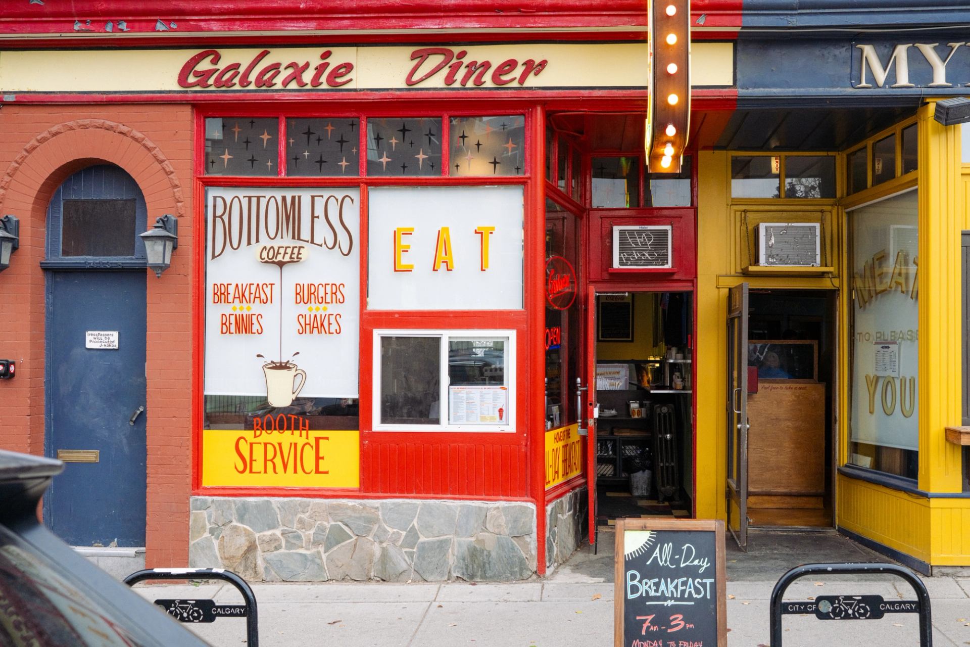 The vibrant red and yellow, retro-styled exterior of Galaxie Diner in Calgary.