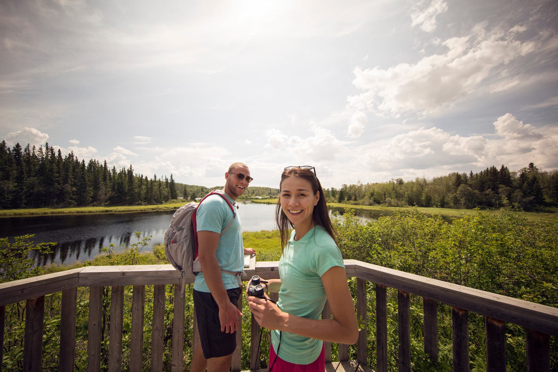 Couple bird watching from a boardwalk lookout in Cold Lake Provincial Park