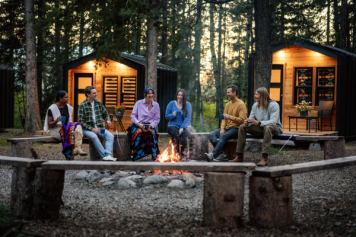 Guests at Painted Warriors Indigenous Outdoor Experience enjoy a campfire.