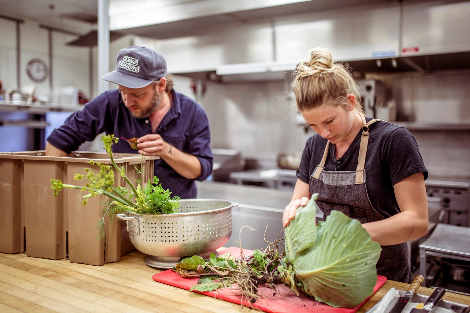 Chefs preparing vegetables in a kitchen