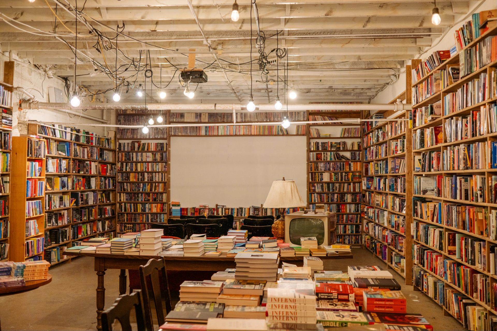Shelves of books line every wall and pile on all surfaces in the basement at The Next Page bookstore in Calgary.