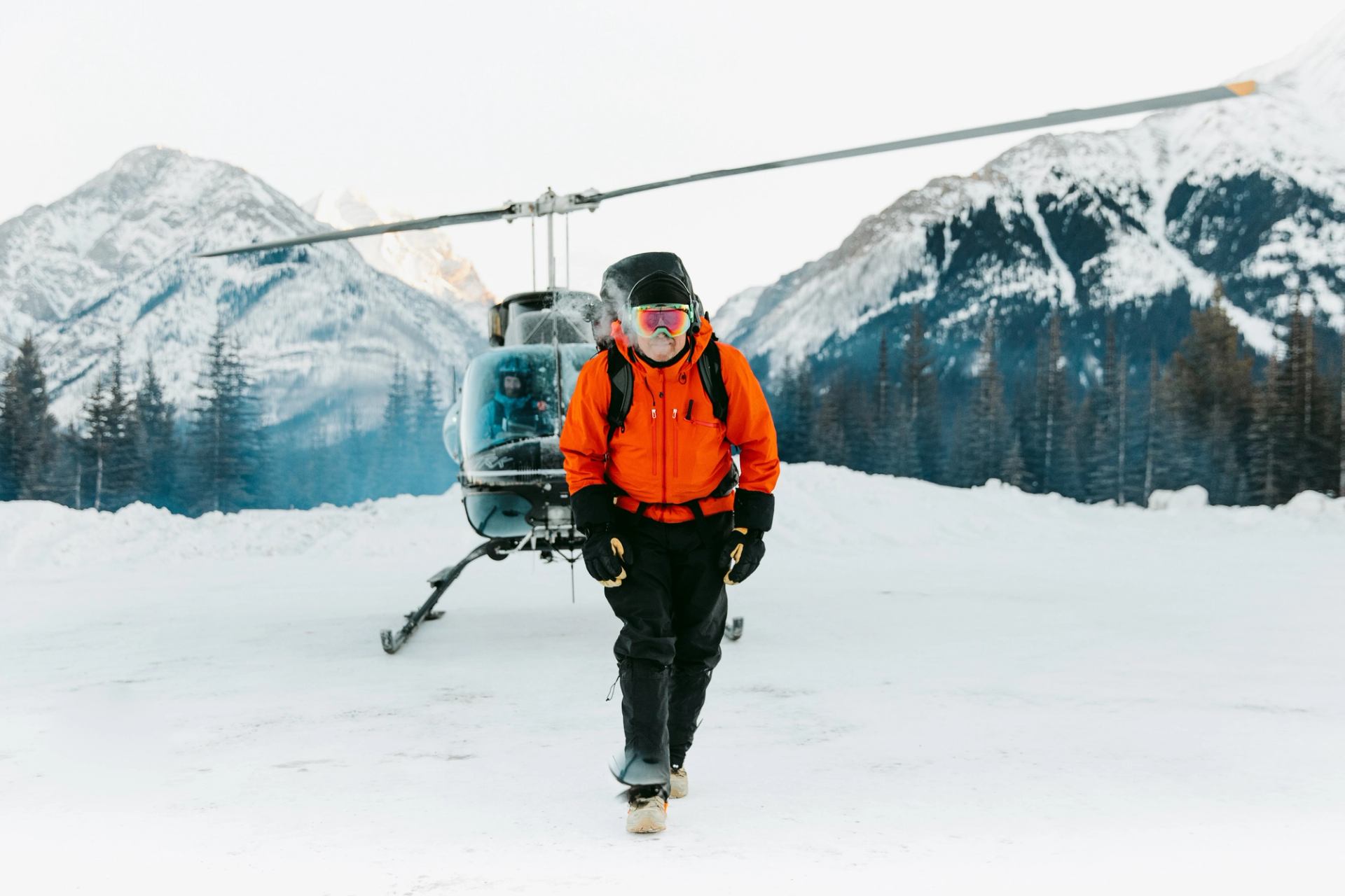 Snowshoe guide with the helicopter in the background