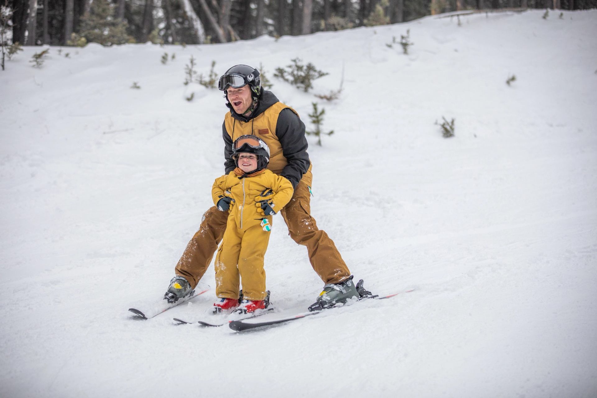 father and toddler skiing at Cypress Hills