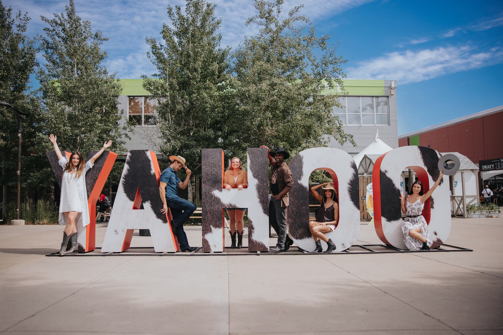 Friends enjoying the yahoo sign at Calgary Stampede.