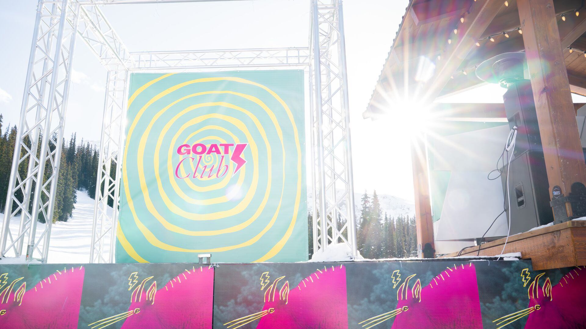 A stage with colourful backdrop at the Goat Club outside at Banff Sunshine Village.
